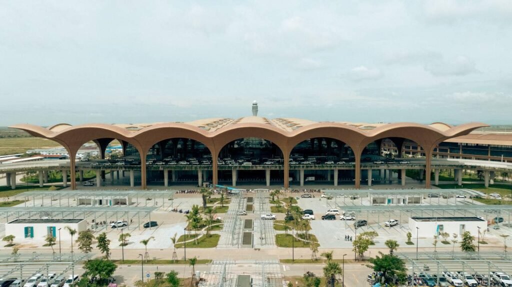Modern transportation hub at Techo International Airport, showing taxis, buses, and potentially a light rail connection.